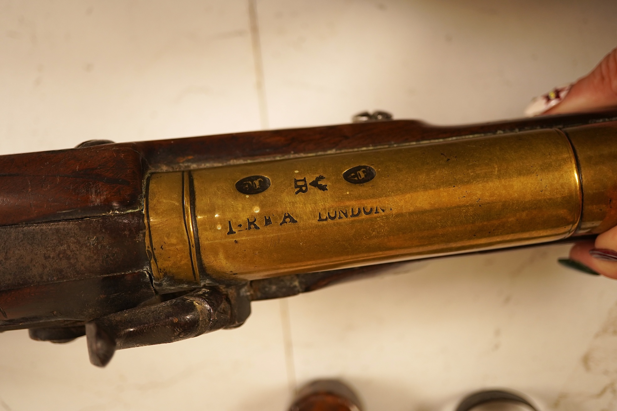 A pair of 19th century pocket pistols, shot flask and a brass musket, 81cm in length